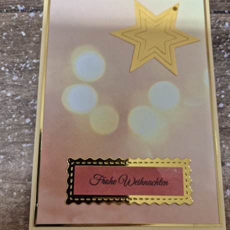 Weihnachtskarte mit Lichterschein und Stern