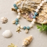 Kauri Muschel Halskette mit Jadeperlen – blau & natur