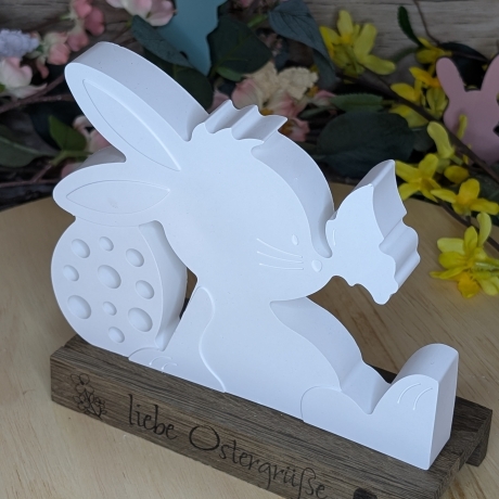 süßer Hase mit Schmetterling mit einem Ostergruß auf Holz