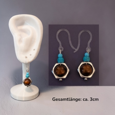 silberfarbene Ohrringe mit Perle