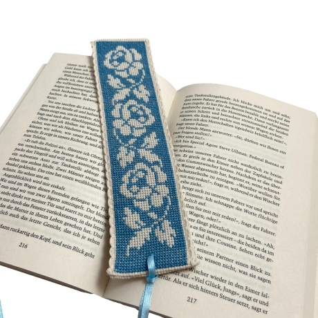 Gesticktes Lesezeichen mit Rosen auf blauem Hintergrund