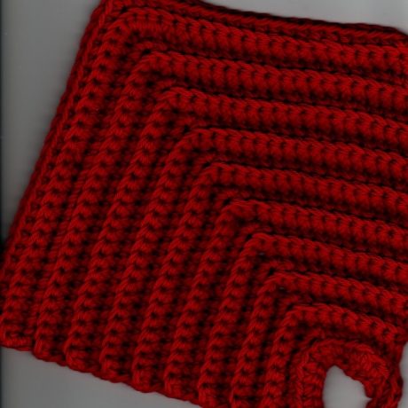 Die etwas kleineren Topflappen im 2er Set aus rotem Baumwollgarn 